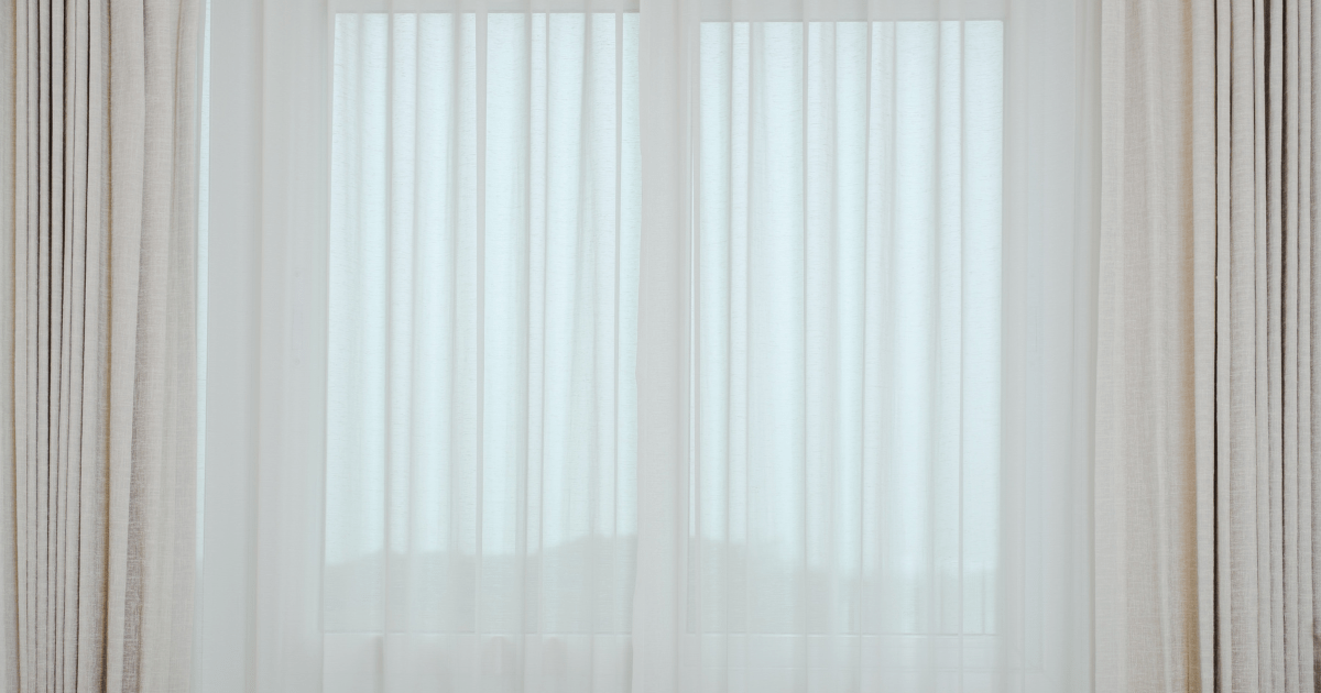 Layered sheer curtains across a wide window