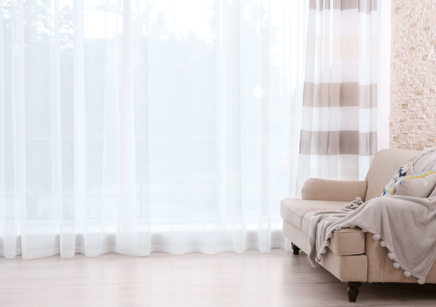 Bright white sheer curtains softly filtering daylight in a living room