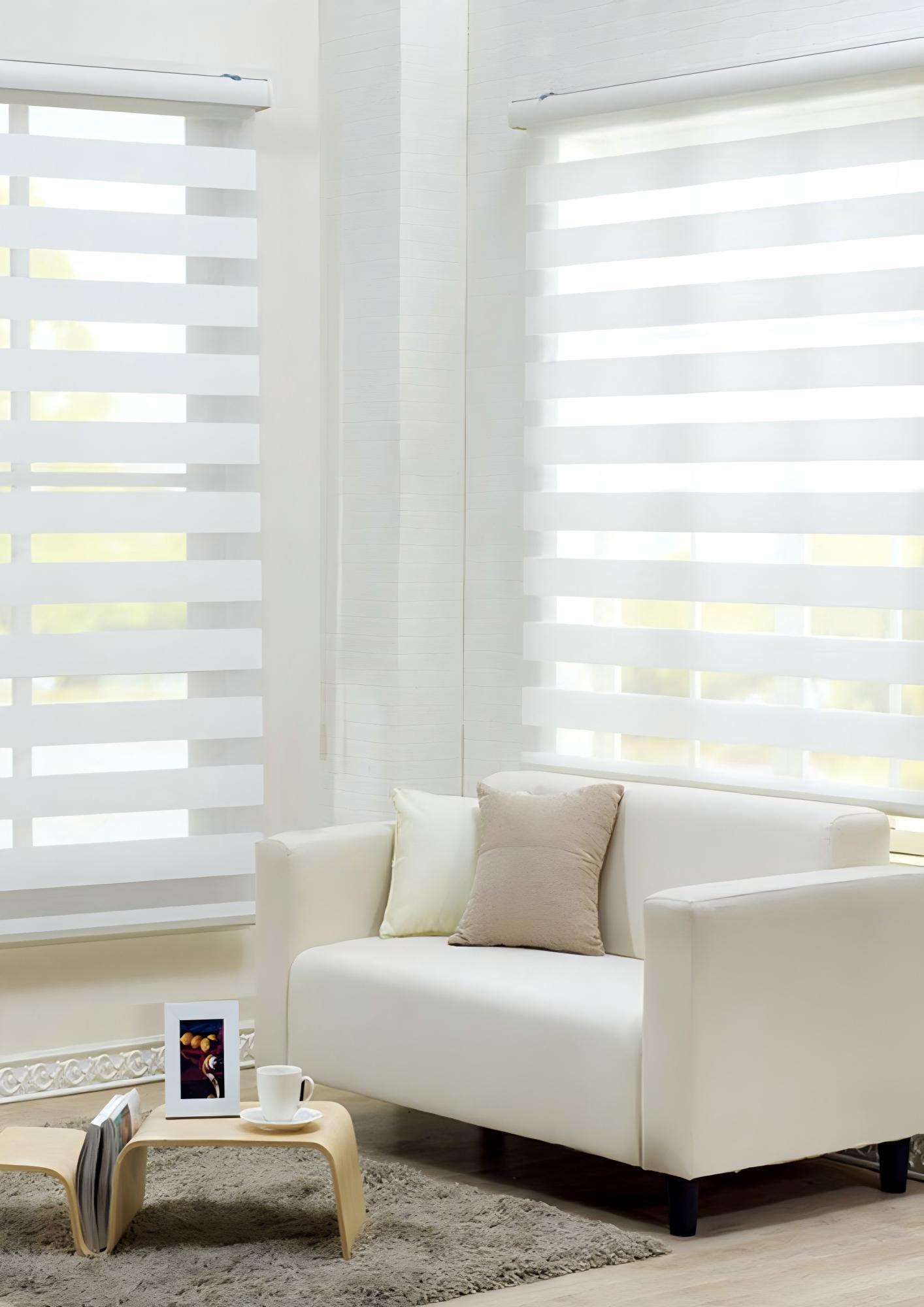 Light-filtering zebra blinds bringing soft daylight into a white living room