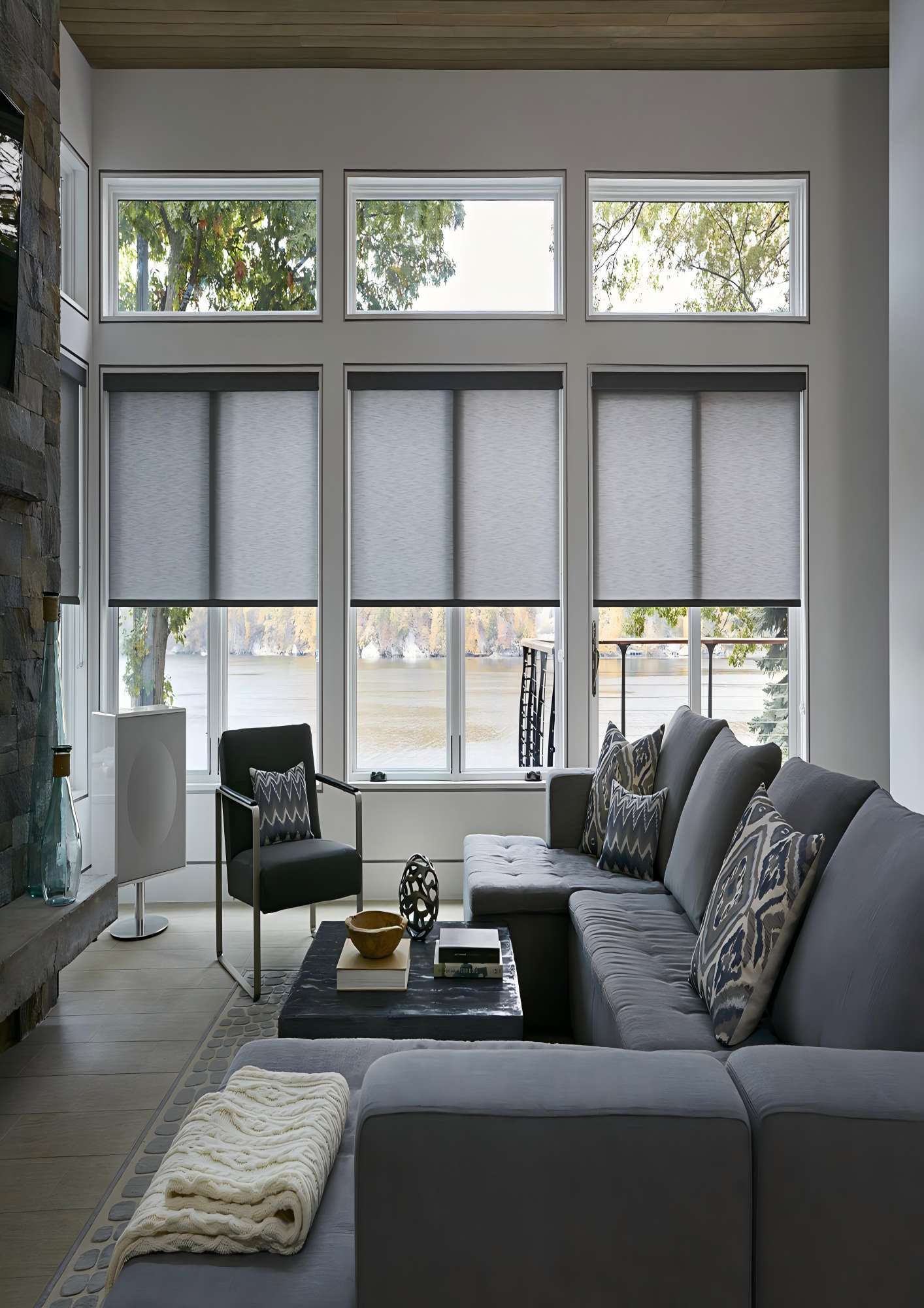 Custom roller shades professionally installed on tall living room windows